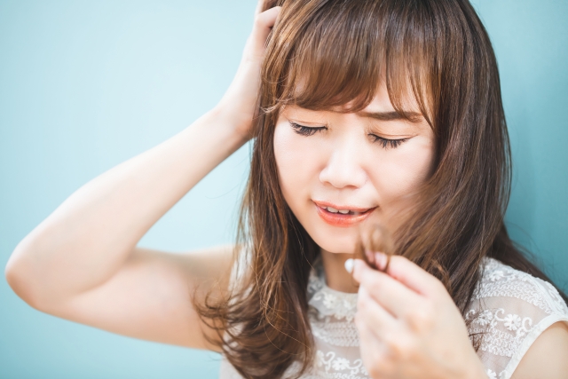 髪がまとまらなくて悩む女性